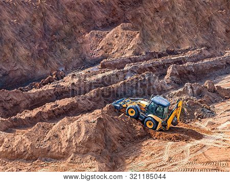 Wheel Loader Excavator Machine Working In Construction Site. Wheel Loader At Sandpit During Earthmov