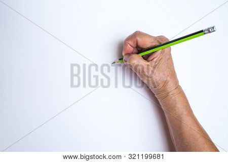 Senior Woman's Hand With Pencil Writing On White Paper