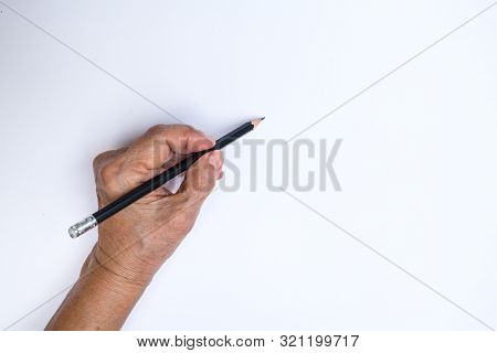 Senior Woman's Left Hand With Pencil Writing On White Paper