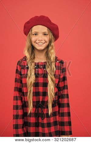 How To Wear Beret Like Fashion Girl. Kid Little Cute Girl With Long Hair Posing In Hat Red Backgroun