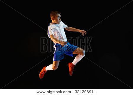 Young Boy As A Soccer Or Football Player In Sportwear Making A Feint Or A Kick With The Ball For A G
