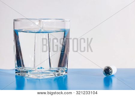Capsule With Camera For Capsular Endoscopy And Glass Of Water