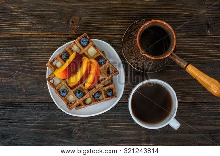 Chocolate Belgian Waffles With Fruits, Cup Of Coffee And Cezve On Wooden Background. Delicious Break