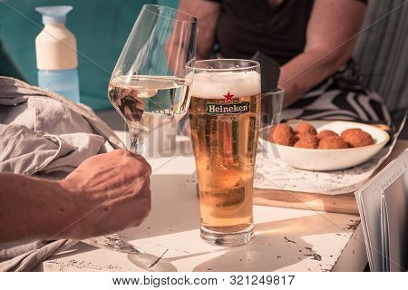Ameland, The Netherlands, 08/31/2019, Toast! Cold Beer, Glass Of White Wine, Bitterballen  On The Ta