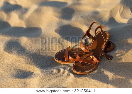 Elegant Brown Women's Sandals On The Sand