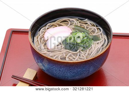 Japanese Kake Soba Noodles In A Ceramic Bowl With Chopsticks On Tray