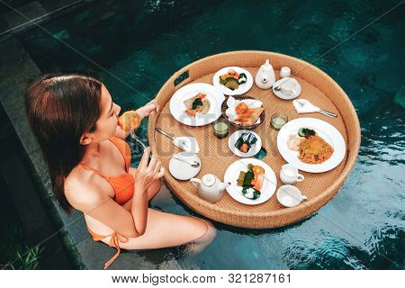 Floating Breakfast In Infinity Pool On Paradise Swimming Pool, Morning In The Tropical Resort Bali, 