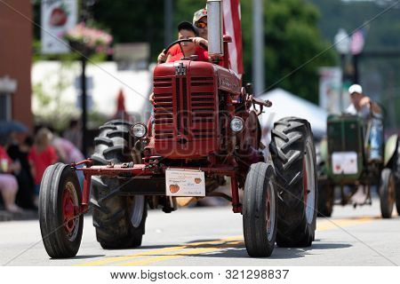 Buckhannon, West Virginia, Usa - May 18, 2019: Strawberry Festival, Old Tractors Being Driven Along 