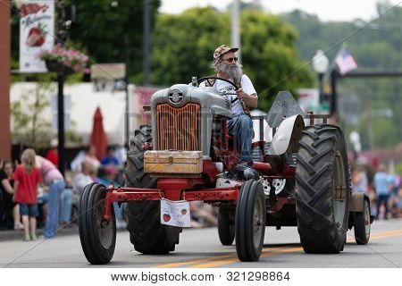 Buckhannon, West Virginia, Usa - May 18, 2019: Strawberry Festival, Old Tractors Being Driven Along 