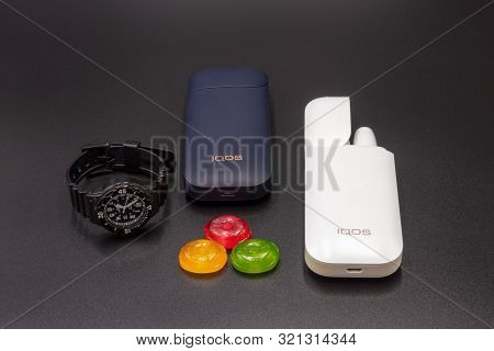 White Iqos Device Battery, Multicolored Sweet Candy, Black Teen Wristwatch And Black Iqos Device Bat