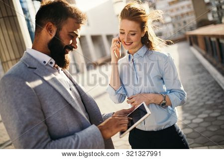Business People Talking, Smiling And Discussing Ideas Outside.