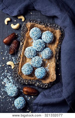 Energy balls with nuts, hemp hearts, blue spirulina and shredded coconut