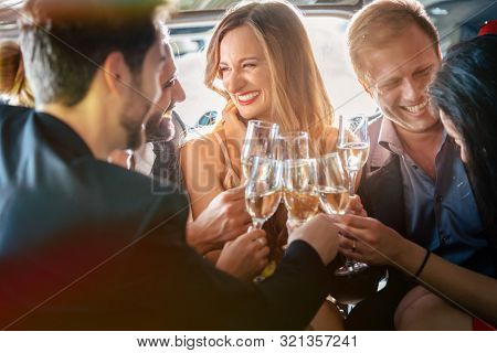 Birthday party in a limo with glasses of champagne