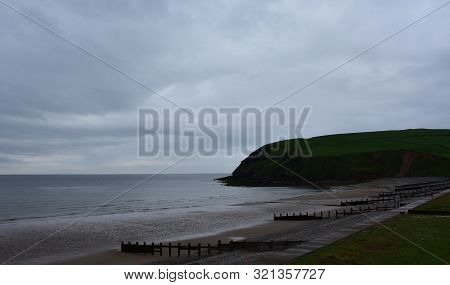 Large Gray Storm Clouds Looming Over The Beach At St Bees.