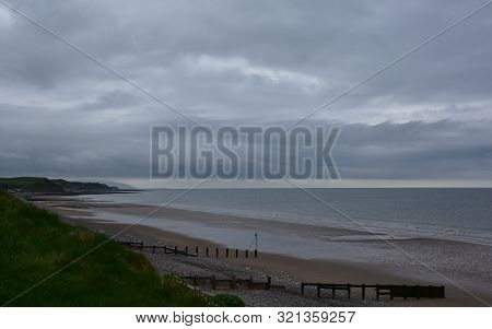 Dark Storm Clouds On The Beach Of St Bees In England.