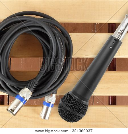 Music And Sound - Xlr Microphone Cable Professional And Black Microphone On A Wooden Background.