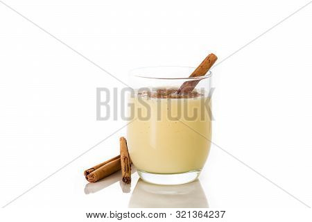 Homemade Eggnog With Cinnamon In Glass Isolated On White Background. Typical Christmas Dessert.