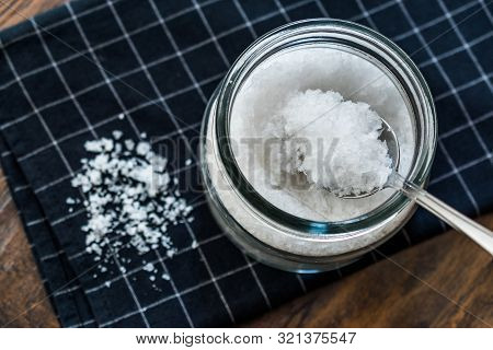 Maldon Sea Salt Flakes In Jar With Spoon.