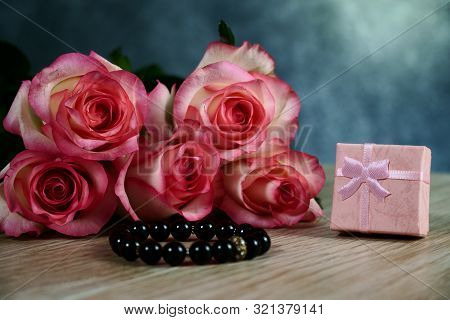 Dolce Vita Roses With Pink Present Box On Wood Background