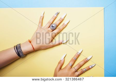 Woman Hands Holding Colorful Paper Copyspace Wearing A Lot Of Jewelry And Long Nails Closeup