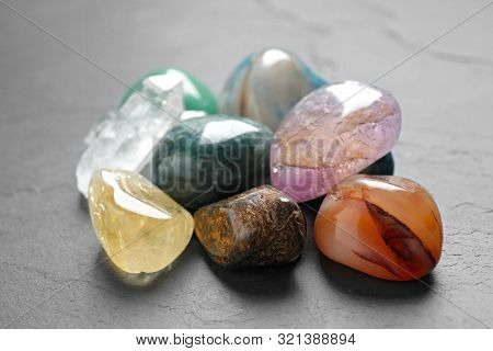 Pile Of Different Beautiful Gemstones On Grey Background