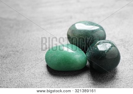 Beautiful Green Gemstones On Grey Table, Space For Text