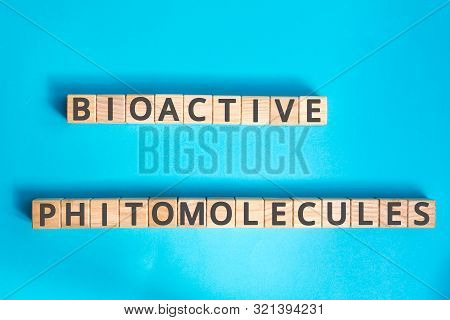 Bioactive Phytomolecules Inscription Wooden Cubes With Letters On A Blue Background