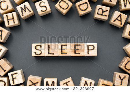 Word Sleep Composed Of Wooden Cubes With Letters, Relaxation Concept, Scattered Around The Cubes Ran