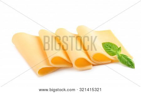 Slices Of Tasty Cheese With Basil On White Background