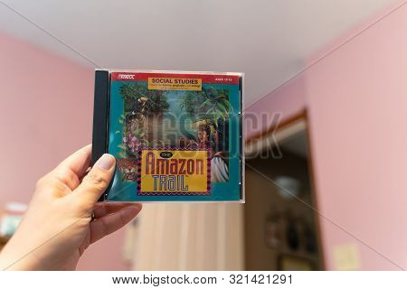 Scandia, Mn - September 10, 2019: Hand Holds Up A Cd-rom Computer Software Game Of The Amazon Trail,