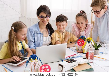 Kids Learning About Computers And Robots With Their Teacher, Studying At Extracurricular Stem Club
