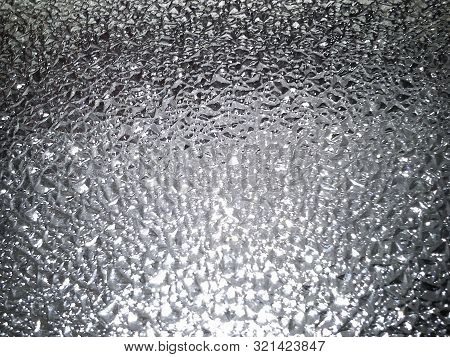 Corrugated Glass On A Gray Background With Play Of Light And Shadow