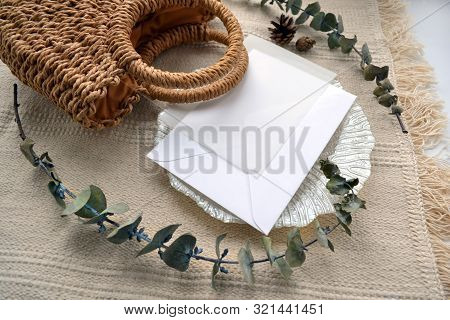 Scene Envelope With Calque, Cone, Woven Straw Bag, Decorative Saucer And Dry Eucalyptus. Elegant Boh