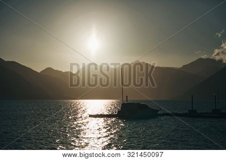 Beautiful Sea View Of Boko Kotor Bay And A Boat At Sunset In Montenegro. Natural Mountain Landscape.