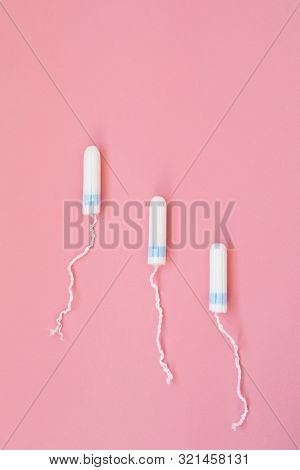 Menstrual Tampon On A Pink Background. Menstruation Time. Hygiene And Protection For Woman