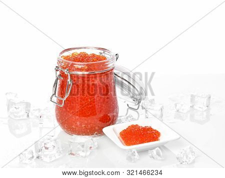 Salmon Or Keta Red Caviar In Jar Can And Little Plate With Ice On Table. Sea Food. Healthy Eating