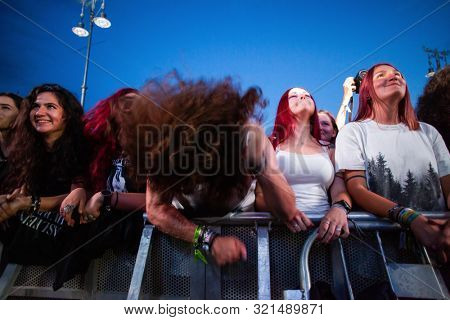 SIBIU, ROMANIA - JULY 26, 2019: Crowd of people headbanging and partying during rock concert at Artmania Festival