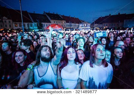 SIBIU, ROMANIA - JULY 26, 2019: Crowd of people headbanging and partying during rock concert at Artmania Festival