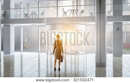Businesswoma in office interior. Mixed media