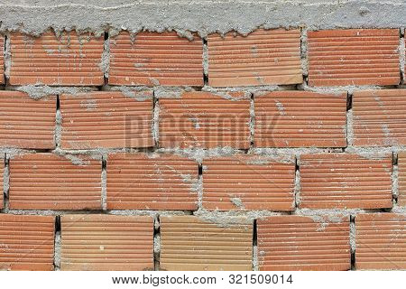 The Pronounced Texture Of Corpulent Brick On The Wall With A Cement Seam With Cement Hat.