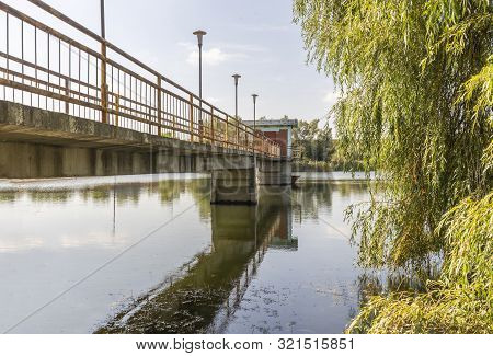 The Bridge To The Middle Of The Lake At Its End Is A Cottage