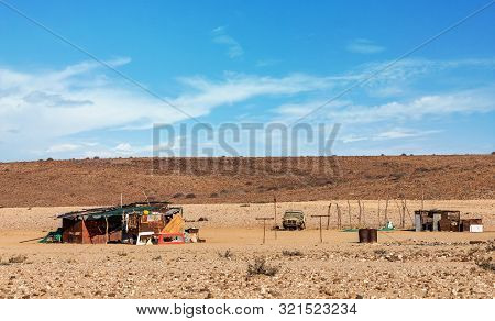 Traditional African House From Sheet Of Tin And Car Wrecks In Desert Of Erongo Region, Namibia