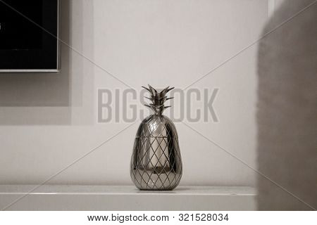 Pineapple Home Accessory Made Of Iron 

Pineapple Shaped House Ornament Standing On White Table