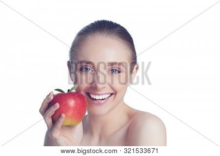 Portrait of happy smiling young beautiful woman eating red apple, over white background