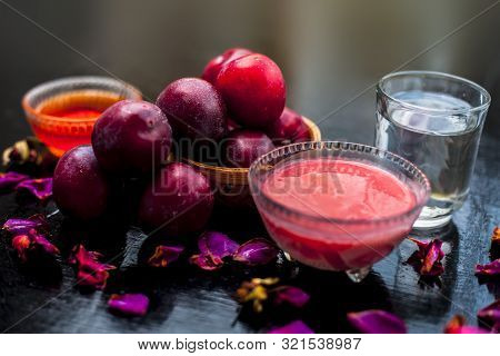 Plum Pulp Well Mixed With Water & Honey In A Glass Bowl Along With Raw Plums Or Prunes Or Aloo Bukha