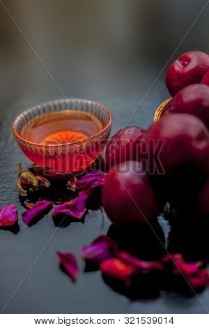Plum Pulp Well Mixed With Water & Honey In A Glass Bowl Along With Raw Plums Or Prunes Or Aloo Bukha
