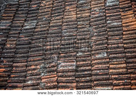 Top Shot Of The Old-styled Rectangular-shaped Rooftop Tiles Fixed On A Roof Of The House.