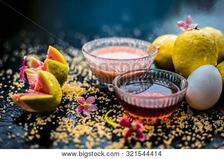 Guava Face Mask For Dry Skin On A Wooden Surface With Vivid Colors I.e., Guava Pulp, Egg Yolk, Oatme