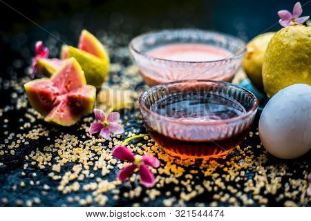 Guava Face Mask For Dry Skin On A Wooden Surface With Vivid Colors I.e., Guava Pulp, Egg Yolk, Oatme