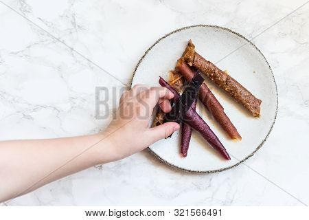 Hand Of Little Child Reaching Sweet Pureed Fruit Roll-up Pastila. Homemade Fruit Leather Of Fruits A